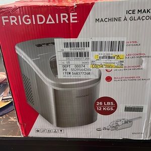 Frigidaire ice maker that’s brand new that sits on the countertop in the kitchen